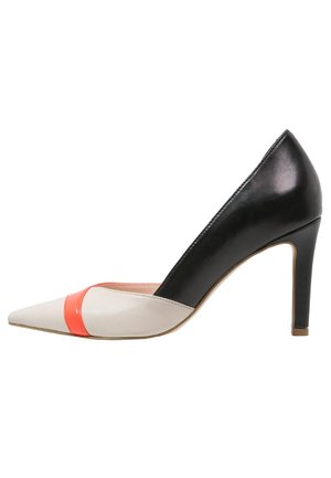 Buty na wysokim obcasie z ostrym noskiem, czarną częścią obcasa, beżowym przodem i wąską pomarańczową opaską blisko palca.
