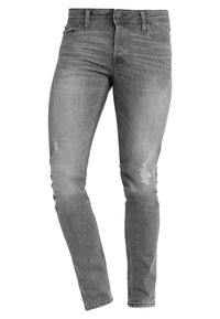 Dopasowane szare dżinsy z denimu z przetarciami, pięciokieszeniowym fasonem, zapięciem na guziki i subtelnym blaknięciem. Materiał z dodatkiem stretchu zapewniający komfort.