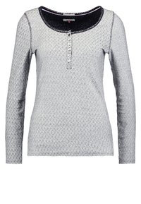 Long-sleeve shirt in gray with a textured diamond pattern, black lace collar, and button placket down the center. Subtle sheen.