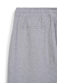 Helle graue Jogginghose mit elastischem Taillenbund, ausgestattet mit einer flachen Gesäßtasche und einem weichen, strukturierten Stoff.