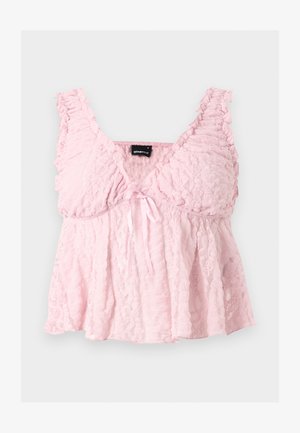Svetloružový čipkovaný crop top s volánikovými ramienkami, výstrihom do V a malou mašličkou v strede vpredu.