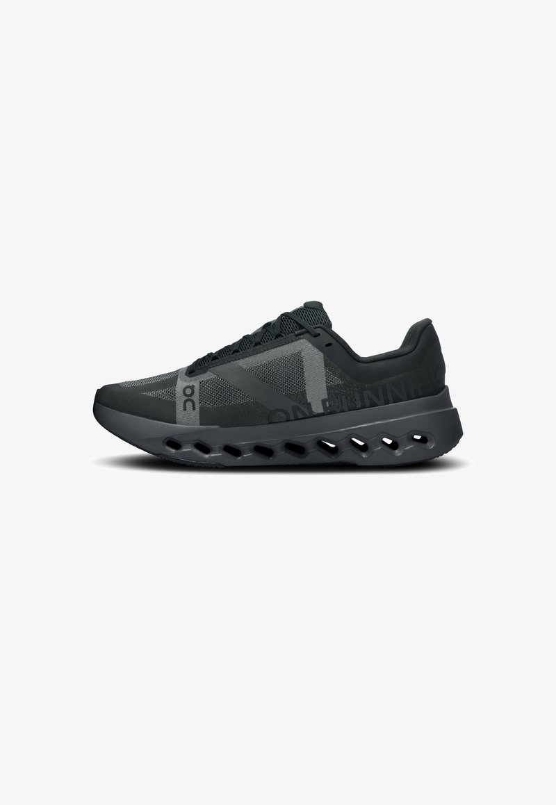Black running shoes with a mesh upper and grey accents. Features a cushioned sole with cut-out designs for ventilation and lightweight support.