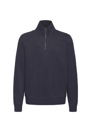 Jersey azul marino con manga larga, media cremallera en la parte delantera, cuello alto y puños y bajo acanalados.
