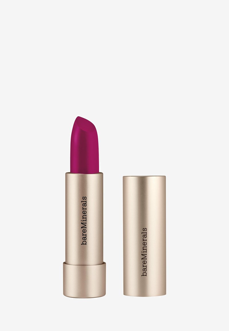 Labial magenta en un tubo de metal dorado, con forma de bala afilada. Marcado con "bareMinerals" en el lado de la tapa.