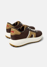 Brown mesh sneakers with beige accents and white soles. Features a textured design and prominent "CAMPer" branding on the heel.