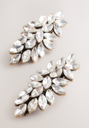 Silver-tone hair clips featuring marquise-cut clear rhinestones arranged in a floral design, with a textured, metallic backing.