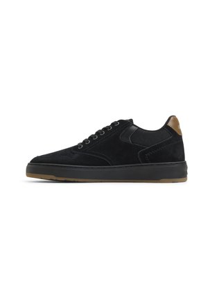 Low-top black suede sneaker with black laces, brown heel tab, and gum rubber sole shown in side profile on white background.