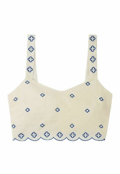Haut court beige clair avec des motifs géométriques bleus, ourlet festonné et fines bretelles avec des détails assortis le long des bords.
