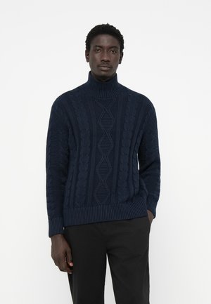 Jersey de cuello alto de punto azul marino con patrones de trenzado texturizados y dobladillo acanalado. Confeccionado en un material espeso y acogedor.