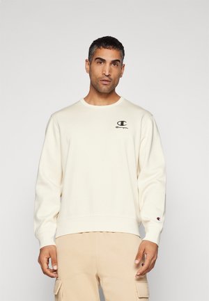 Cremfarbener Sweatshirt mit gerippten Bündchen und Saum, versehen mit einem schwarzen Logo auf der Brust. Weicher Stoff, lockere Passform und runder Halsausschnitt.