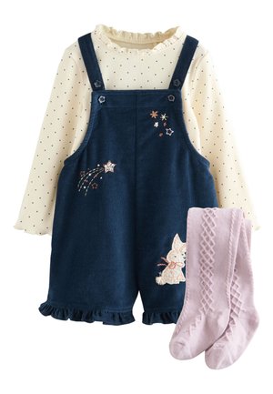 Crèmekleurige top met lange mouwen met kleine marineblauwe stippen, marineblauwe ribfluwelen romper met ster- en konijnenborduursel en roze gestructureerde gebreide maillot.