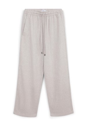 Light beige wide-leg pants with elastic waistband, drawstring, and side pockets, made from textured fabric.