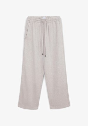 Pantalons larges de couleur beige clair avec taille élastique, cordon de serrage, et poches latérales, fabriqués à partir d'un tissu texturé.