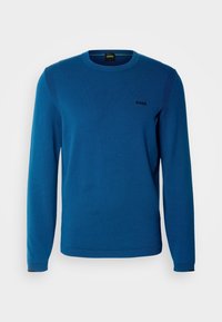 Pull bleu à manches longues col rond avec des détails côtelés aux épaules et aux poignets, avec un petit logo noir "BOSS" sur la poitrine gauche.