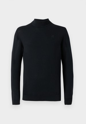 Mustmustükk mustast kudumist. Omab slim-fit lõiget, pikad varrukad, ribadest mansetid ja diskreetne logo rinnal.
