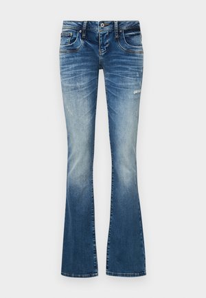 Jean flare en denim bleu avec des détails délavés et usés, fermeture à bouton et zip à l'avant, et design à cinq poches.