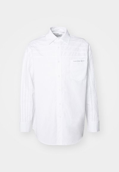 Weißes Langarmhemd aus Baumwolle. Mit Knopfleiste, Kragen und einer linken Brusttasche mit subtiler Markenkennzeichnung. Strukturiertes seitliches Design.
