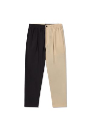 Two-tone trousers with an elastic waistband; one side in black, the other in beige, featuring a smooth texture and tailored pleats.