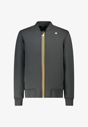 Giacca grigia con zip e colletto rialzato, caratterizzata da una zip con strisce bianche e gialle. Realizzata in tessuto liscio, con polsini e orlo a costine.