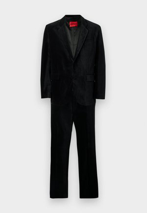 Black suit featuring a single-button blazer with notch lapels and matching trousers, made of soft material with a smooth texture. HUGO label visible.