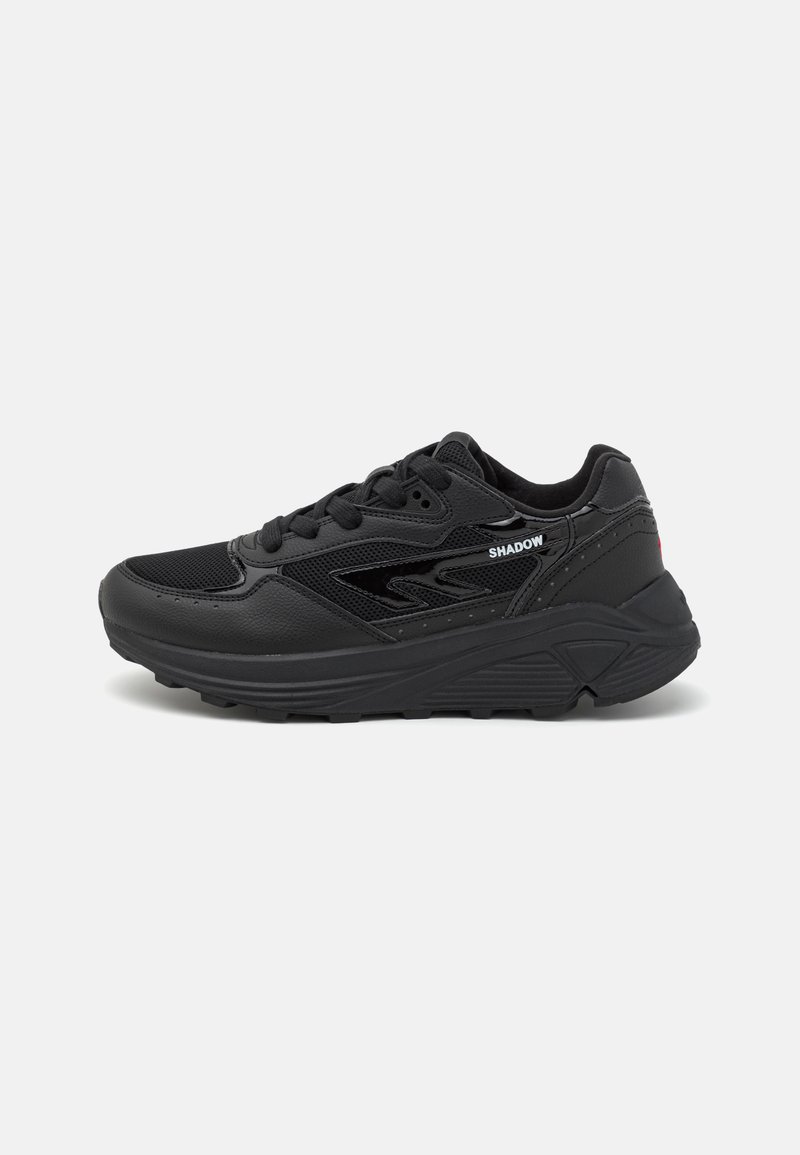 Black athletic shoes with a textured leather and mesh upper, padded collar, lace-up design, and a thick rubber sole featuring grooves.