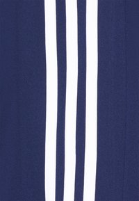 Navy blue fabric featuring three vertical white stripes. Smooth texture, athletic design, suitable for sports or casual wear.
