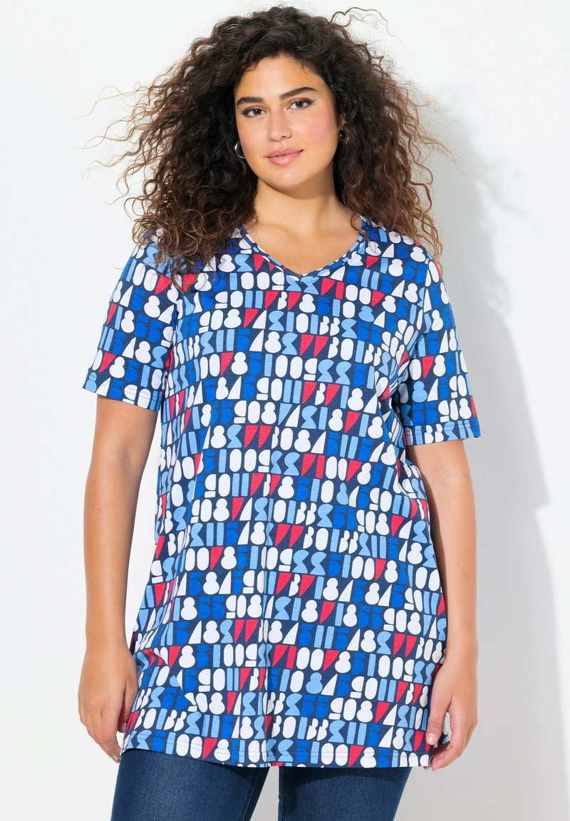 Tunique à col en V à manches courtes en bleu avec des motifs géométriques en blanc et rouge. Tissu doux avec une coupe décontractée, arrivant au niveau des hanches.