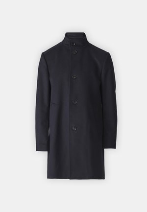 Navy wool overcoat with a high collar, front button closure, and side pockets. Straight-cut design, smooth texture, no visible patterns.