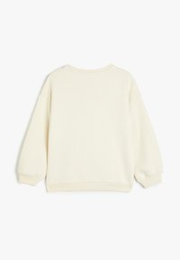 Sudadera de gran tamaño de color crema con cuello redondo, hombros caídos y puños y dobladillo acanalados. Material suave y parecido al forro polar.