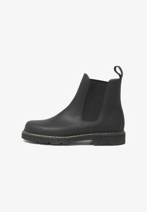 Black leather Chelsea boots with elastic side panels, rounded toe, pull tab, and textured rubber sole featuring a contrasting stitch detail.