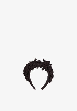 Fascia per capelli nera lavorata a maglia con filato spesso e ritorto che forma forme floreali in rilievo e strutturate lungo la parte superiore e i lati.