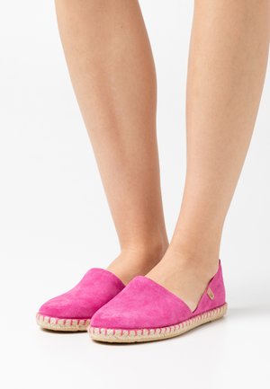 Fuchsia suede slip-on shoes with a woven jute sole and espadrille style, featuring a soft texture and rounded toe design.