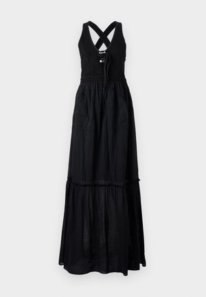 Abito maxi nero con design senza maniche, spalline incrociate, vita con coulisse, due tasche laterali e gonna a strati e fluida.