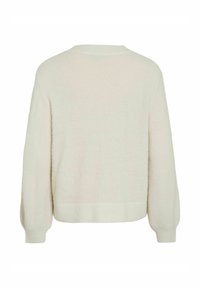 Minkštas šviesaus smėlio spalvos plačios formos megztinis iš tvaraus siūlo. Turi apvalią apykaklę bei ribinius rankogalius ir apačią.