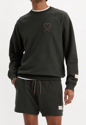Dark green sweatshirt with raglan sleeves, featuring a heart design. Paired with matching shorts, accented with multicolored drawstring.