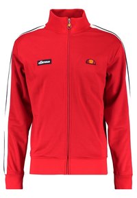 Rød lynlåstrøje i glat stof med sorte og hvide striber på siden, broderet logo på brystet og to forlommer.