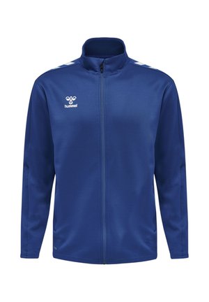 Kék, végigzipzárazható sportdzseki fehér Hummel logóval a mellkason és fehér halszálka csíkokkal a vállakon.