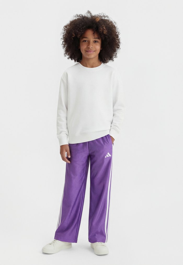 adidas SEASONALS GLAM WIDE LEG PANTS JUNIOR UNISEX - Tracksuit bottoms - active purple