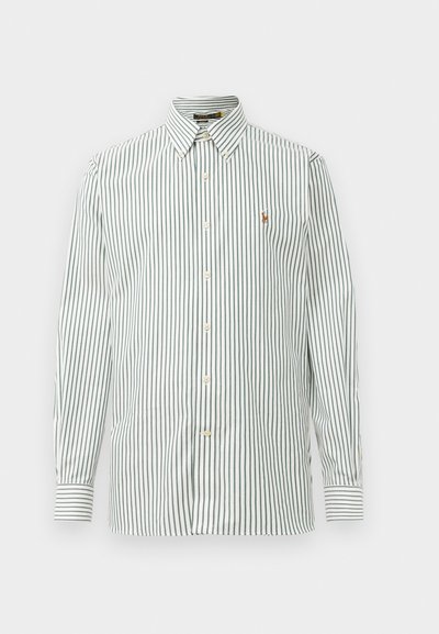 Rutet knappskjorte i hvit med grønne vertikale linjer, med klassisk krage og en liten logo på brystet. Bomullsstoff.