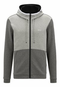 Felpa grigia con zip e una sezione inferiore di un grigio più scuro. Presenta un cappuccio, un cordino e un piccolo logo sul petto. Tessuto morbido.