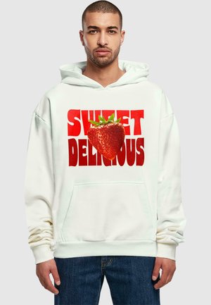 White hoodie with a large graphic design featuring the text "SWEET" in red and "DELICIOUS" in bold letters, alongside a strawberry image.