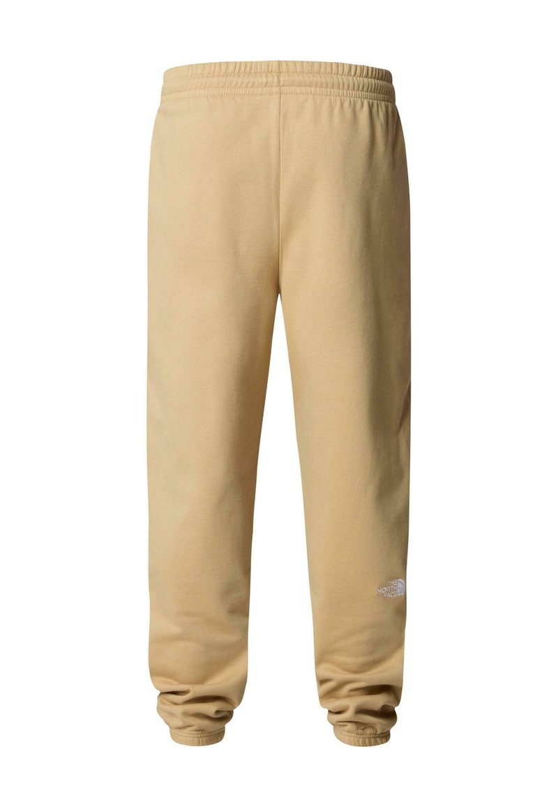 Pantalons de survêtement beige en tissu doux, dotés d'une taille élastique et de poignets. Comprend un petit logo blanc sur la jambe inférieure.