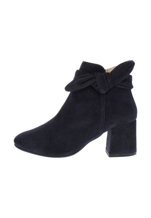 Navy suede ankle boots with a block heel, pointed toe, and a fabric bow accent at the cuff, featuring stitching details.