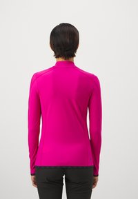 Langärmliges Oberteil in leuchtendem Pink, gefertigt aus glattem, dehnbarem Material. Verfügt über einen hohen Kragen und ein tailliertes Design mit einem kontrastierenden schwarzen Saum.