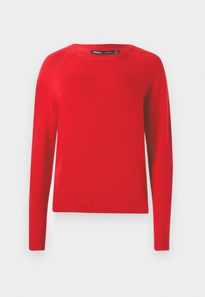 Pull rouge en tissu lisse, avec un col rond, des poignets et un ourlet côtelés. Design simple avec des manches longues.