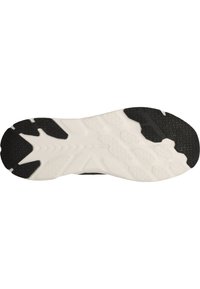 Suela de zapatilla deportiva en blanco y negro con patrones de goma texturizados para agarre, forma curva y diferentes texturas en la superficie.