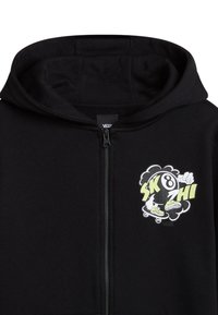Hoodie zippé noir en mélange de coton avec capuche à cordon. Présente un graphique coloré d'une figure de skateboard sur la poitrine.