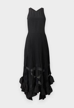 Μαύρο αμάνικο φόρεμα με εφαρμοστή μπούστο, πλισέ φούστα, διαφανείς λεπτομέρειες και βολάν σε ασύμμετρο τελείωμα.