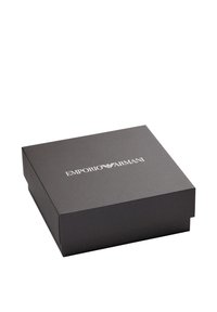 Caja de cartón negra con tapa abatible, con el texto en relieve "EMPORIO ARMANI" en blanco en la parte superior, textura lisa.