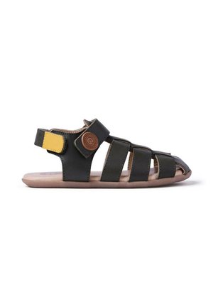Sandalia abierta negra y beige con tres tiras delanteras, tira en el tobillo con un parche amarillo y logo redondo marrón en el lateral.